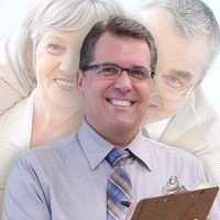 Scott Bryant's family Smiling, clean cut man with glasses with an older man and woman looking over his shoulders